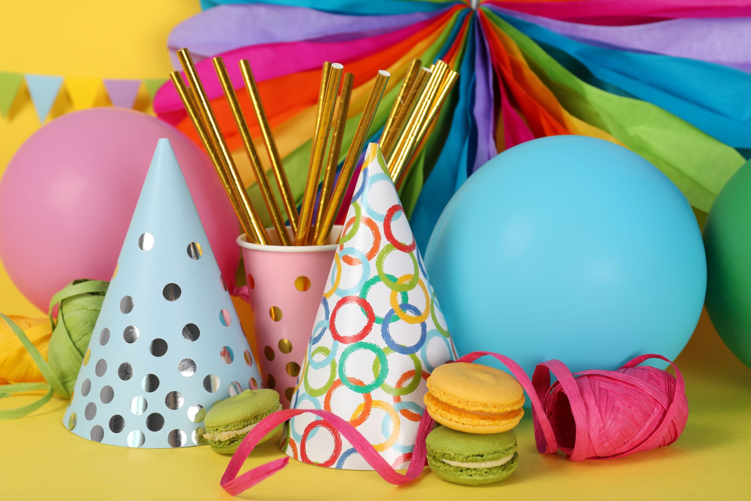 different-multicolored-birthday-accessories-yellow-background